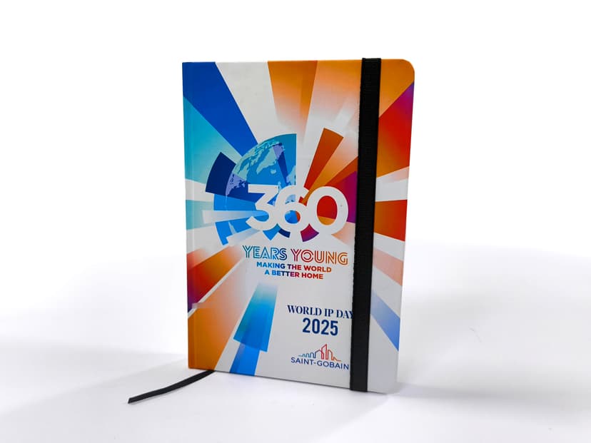 Custom Saint-Gobain hardcover diary with vibrant cover and elastic band.